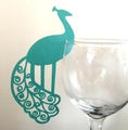 Close-up of laser-cut peacock wine glass card in teal paper for wedding table decor - Tiffany Blue