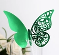 Close-up of laser-cut green butterfly paper card for glass rim decoration - Reflective Green