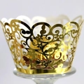 Hollow gold cupcake wrapper with laser-cut floral pattern holding chocolate on a stand - Reflective Gold