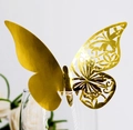 Elegant gold butterfly place card with laser-cut hollow design on a wine glass rim - Reflective Gold