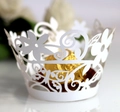 Macro shot of white laser-cut cupcake wrappers with intricate floral lace for party decor - 5cm / White