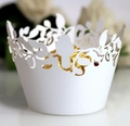 Macro shot of white laser-cut cupcake wrapper with bird and vine patterns for weddings - 5cm / White