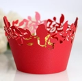 Macro shot of laser-cut red paper cupcake wrapper with bird motif holding a gold truffle - 5cm / Pearlescent Red