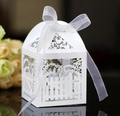 Elegant laser-cut white wedding favor box with ornate fence patterns and white ribbon bow - White