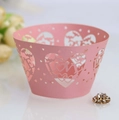 Detail of pink laser-cut cupcake wrapper with heart patterns and LOVE lettering - Pink
