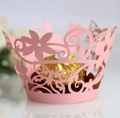 Macro detail of laser-cut pink muffin liners with crown patterns and flower lace - 5cm / Pink