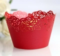 Macro view of laser-cut red paper cupcake wrappers featuring delicate rose patterns - Pearlescent Red