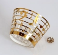 Detail of laser-cut gold musical note cupcake wrapper with elegant staff patterns - Reflective Gold (WB-67)