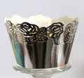 Macro shot of laser-cut rose hollow cupcake wrappers with a shiny silver metallic finish - Reflective Silver