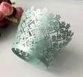 Detail of mint green laser-cut floral cupcake wrappers for wedding and party decoration - Sea Blue Green