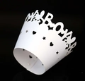 Laser-cut white cupcake wrappers with BOY lettering and star patterns for party decor - White