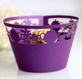 Close-up of laser-cut purple cupcake wrapper with teapot floral patterns and chocolate - Dark Purple