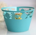 Close-up of laser-cut cupcake wrapper with pearlized finish and teapot floral patterns - Tiffany Blue