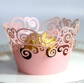 Pink laser-cut cupcake wrapper with intricate scroll pattern for party decor - Pink