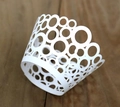 Laser cut white cupcake wrappers with circular hollow pattern for wedding party decoration - White