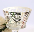 Macro view of laser-cut lace cupcake wrappers with elegant gold mirror finish - Reflective Silver