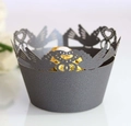Macro shot of laser-cut cupcake wrapper featuring heart and birds in dark grey finish - Silver Charcoal