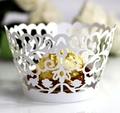 Macro view of white laser-cut cupcake wrapper with floral lace patterns and scalloped edge - 5cm / White
