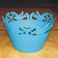 Intricate laser-cut blue cupcake wrappers featuring bird and heart patterns on wood - Sky Blue