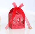 Detail of red laser-cut wedding candy box with intricate floral hollow patterns and ribbon - Pearlescent Red