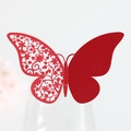 Detail of red laser-cut butterfly place card with floral patterns on a wine glass rim - Pearlescent Red