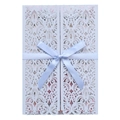 Detail of light blue laser-cut wedding invitation with silk bow and intricate patterns - Fog Blue