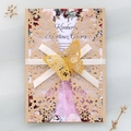 Detail of laser-cut wedding invitation with gold glitter butterfly and ribbon closure - Champagne Gold