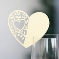 Macro detail of laser-cut heart place card in cream pearlescent paper on wine glass - Platinum
