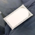 Detailed macro view of white laser-cut lace card with delicate floral hollow patterns - Ivory