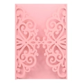 Close-up of pink laser-cut wedding invitation cover with intricate scrollwork patterns - Pink