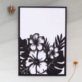 Laser cut invitation card with tropical leaf design and white inner sheet on grey fabric - Black