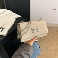 Chic beige shoulder bag with silver metallic bow detail and chain strap in glossy finish - Khaki