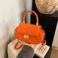 Quilted crossbody bag in vibrant orange with metallic clasp and curved handle - Orange