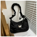 Black pleated underarm bag featuring a silver butterfly buckle and ruffled shoulder strap - Black