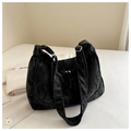 Close-up of large black hobo bag with crinkled texture and silver metal zipper detail - Black