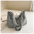 Detail of grey pleated PU leather bag with cloud-like texture and adjustable strap - Silver