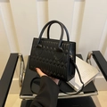 Classic black quilted crossbody bag with golden hardware and round top handles - Black