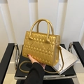 Golden quilted crossbody bag with luxury metallic finish and structured top handle design - Gold