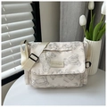 Detalle de un bolso tote de nailon beige con estampado de oso y cierre de solapa - Blanco Roto