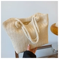Detail of V-shaped straw weave texture and white rope handle with tassel on summer tote bag - Off White