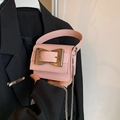 Pink mini crossbody bag featuring a large metallic bow buckle and chain shoulder strap - Pink