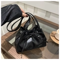 Minimalist black drawstring bucket bag with bow detail and silver hardware accents - Black