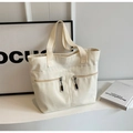 Off-white canvas tote bag with functional dual front zipper pockets and shoulder straps - Off White