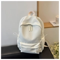 Detail view of a cream-colored large capacity backpack on a bench with side pockets - White