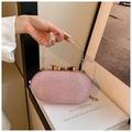 Pink sequin evening clutch bag with golden ring handle and elegant bow clasp - Pink