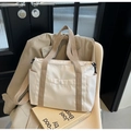 Minimalist beige nylon tote bag with wide shoulder strap and front snap pocket for women - Off White