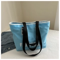 Sky blue waterproof nylon tote bag with white trim and black handles for travel - Blue