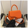 Bright orange crossbody saddle bag with woven handle and wavy flap design - Orange