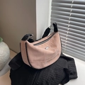 Pink dumpling bag with water ripple texture and wide black adjustable shoulder strap - Pink