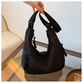 Detail of black nylon crescent bag with woven rope zipper pull and adjustable strap - Black